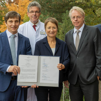 A group of people with an official document