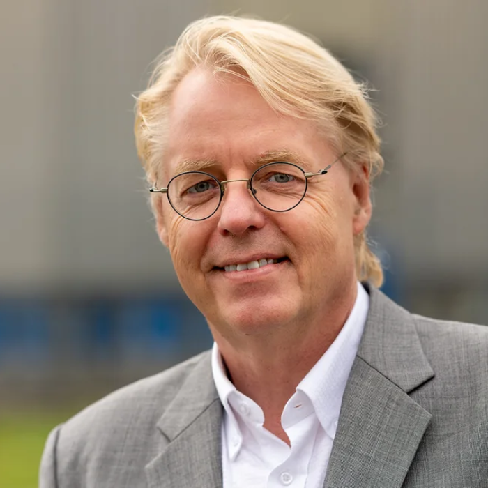 Man in gray suit and white shirt outdoors